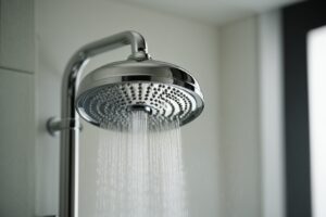 Contemporary shower head with water flowing down.